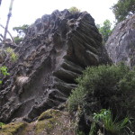 Massive upended boulder with extensive striations