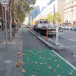 Curbed, dedicated bike lane decked in green paint