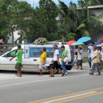 A funeral procession through Moalboal far from the storm