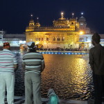 Thousands stand in prayer at the Golden Temple