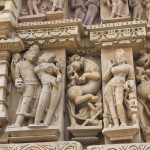 Demure divine love and primping attendant at Khajuraho