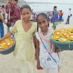 Votive candle sellers on the banks of the Ganges at Asi Ghat