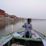 Our boatman in the still Ganges at dawn