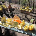 Carved sulfur objects for sale to trekkers, with hauler resting