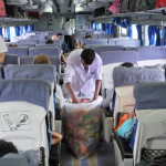 Stewards work the crowd aboard the train across Bangladesh