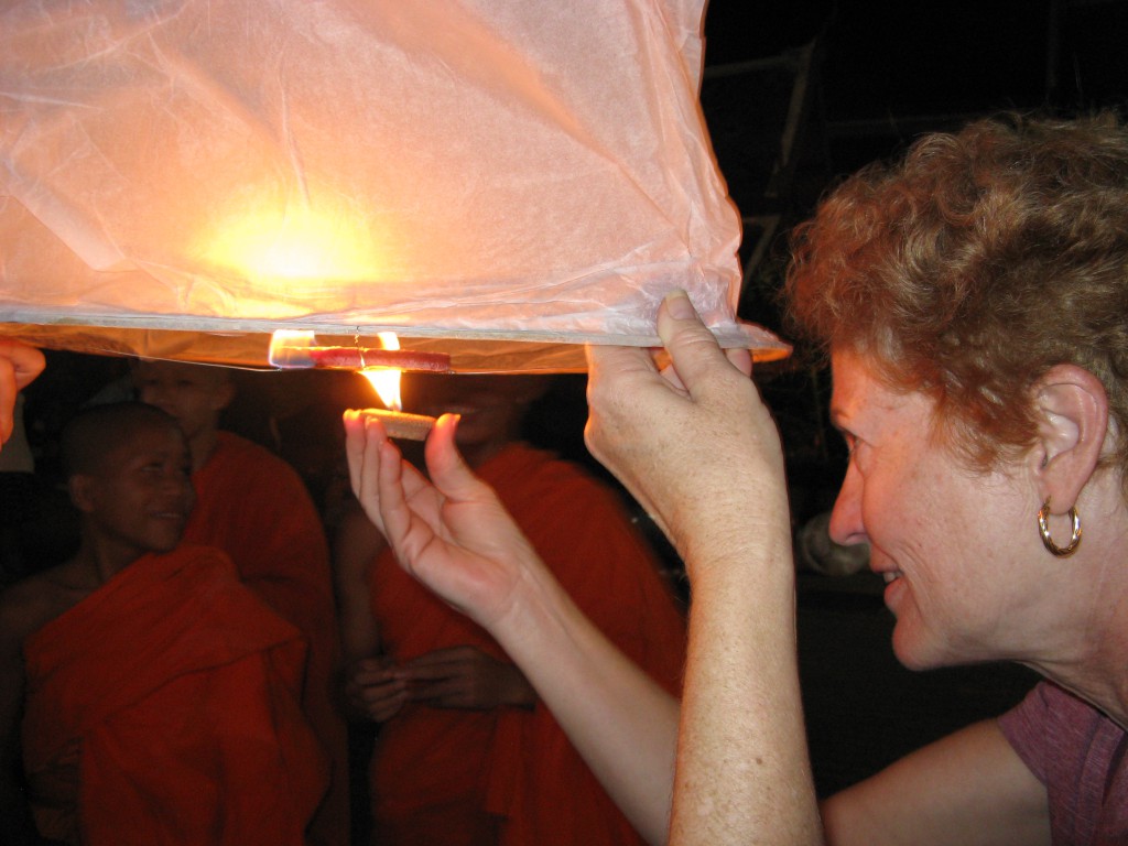 Lighting the lantern/hot air balloon with the help of monks