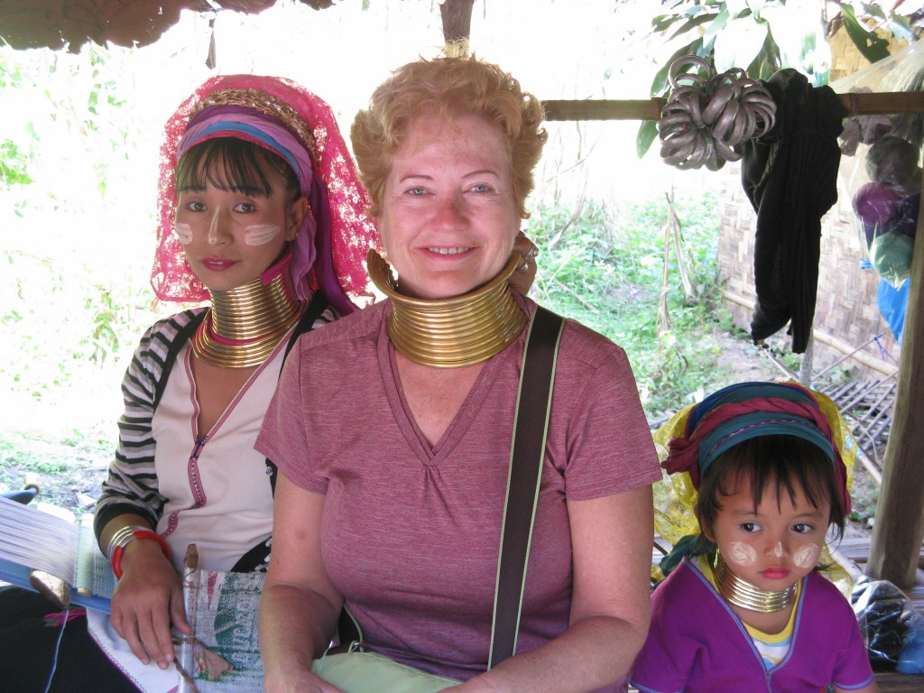 Cheesy tourist photo with long-necked tribal woman and child